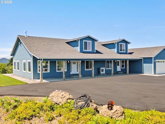 1091 N Echo Mountain Rd, Otis, OR 97368 - view of front facade with a porch, a shingled roof, and driveway
