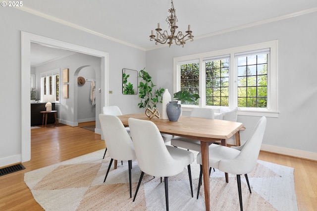 436 SE 44th Ave, Portland, OR 97215 - dining area with crown molding, a chandelier, and light wood finished floors