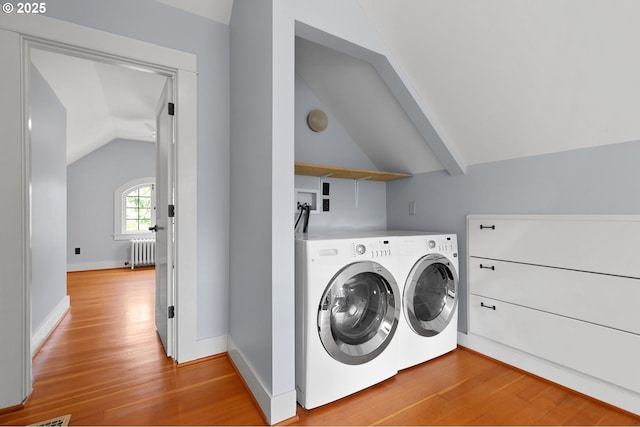 436 SE 44th Ave, Portland, OR 97215 - washroom with radiator, washing machine and clothes dryer, and light wood-type flooring