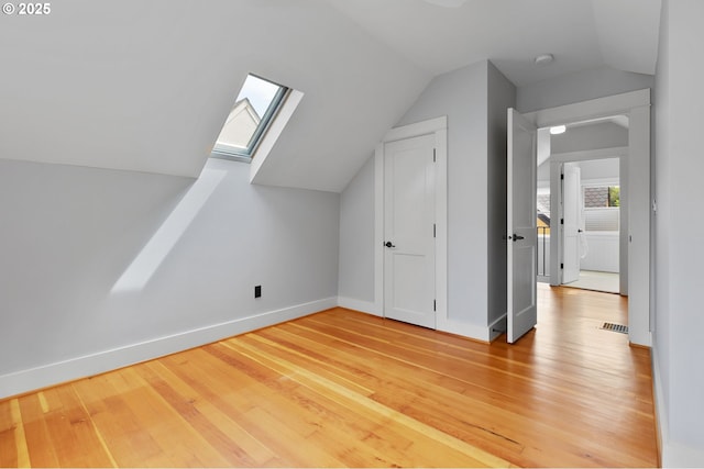 436 SE 44th Ave, Portland, OR 97215 - additional living space with vaulted ceiling, a skylight, and light wood-style flooring