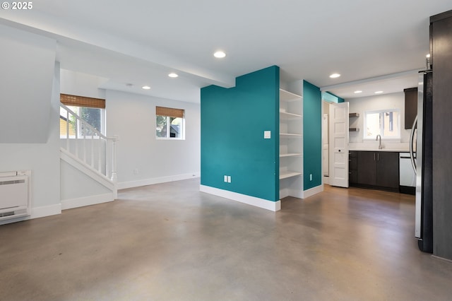 436 SE 44th Ave, Portland, OR 97215 - unfurnished living room with finished concrete floors, stairway, healthy amount of natural light, recessed lighting, and heating unit