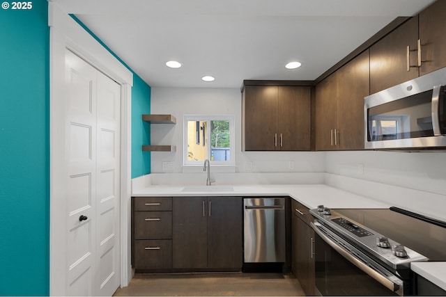 436 SE 44th Ave, Portland, OR 97215 - kitchen featuring appliances with stainless steel finishes, dark brown cabinetry, light countertops, and recessed lighting
