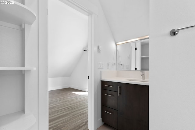 436 SE 44th Ave, Portland, OR 97215 - bathroom featuring vanity, wood finished floors, and vaulted ceiling