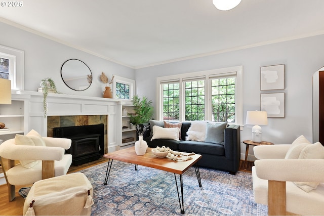 436 SE 44th Ave, Portland, OR 97215 - living room with healthy amount of natural light, crown molding, a tile fireplace, wood finished floors, and arched walkways