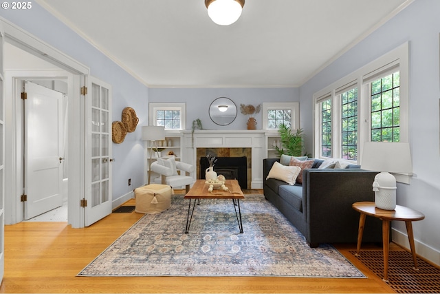 436 SE 44th Ave, Portland, OR 97215 - living room featuring wood finished floors, crown molding, and a tile fireplace