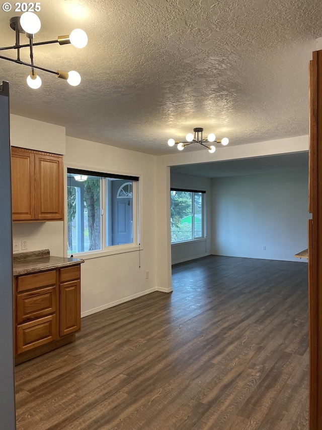 interior space featuring dark wood-type flooring and a textured ceiling