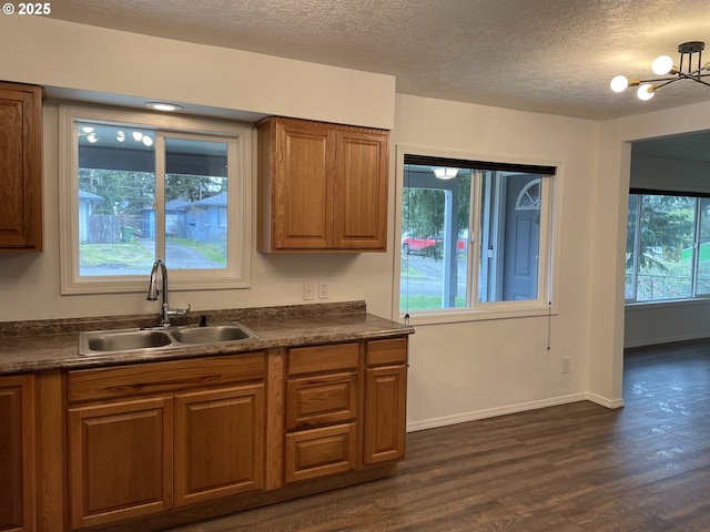 kitchen featuring sink, a textured ceiling, and dark hardwood / wood-style floors