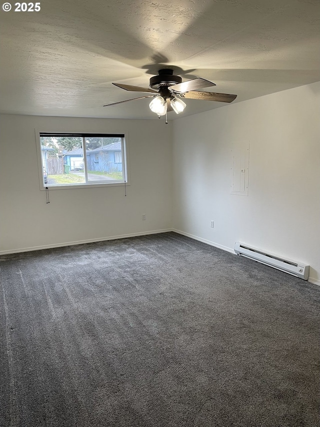 empty room featuring baseboard heating, a textured ceiling, and dark colored carpet