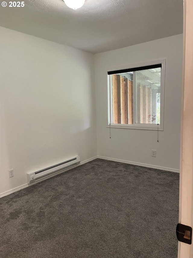 empty room with a baseboard radiator and dark carpet