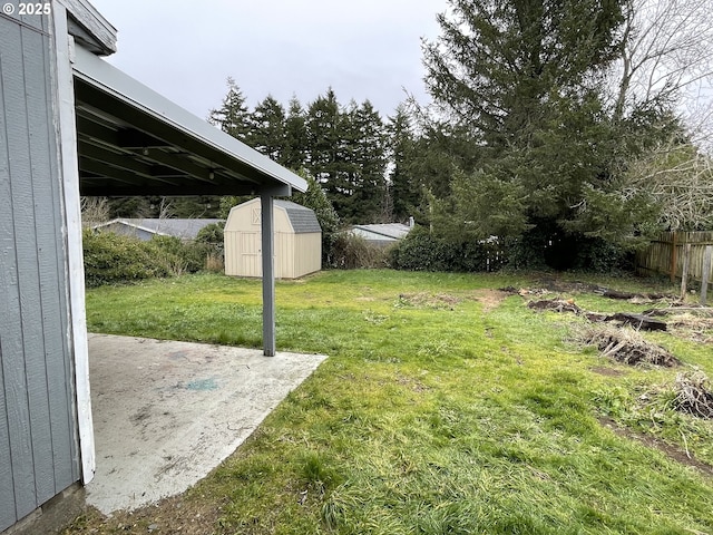 view of yard with a storage shed and a patio area