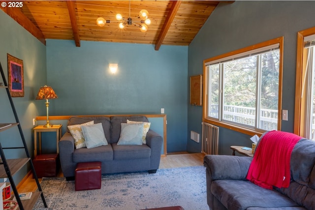 26750 David Ave, Rockaway Beach, OR 97136 - living room with wood finished floors, wood ceiling, a chandelier, and radiator heating unit