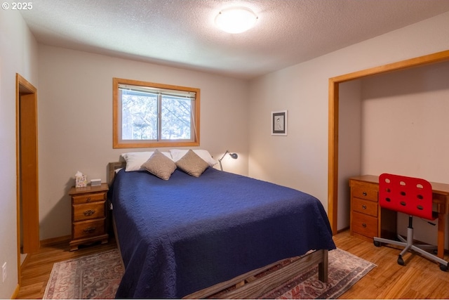 26750 David Ave, Rockaway Beach, OR 97136 - bedroom featuring light wood finished floors and a textured ceiling