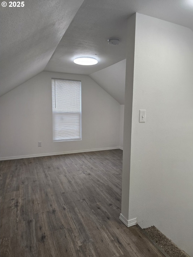 4070 Barger Dr, Eugene, OR 97402 - bonus room with dark wood-style flooring, lofted ceiling, and a textured ceiling