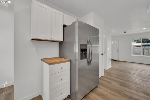 4070 Barger Dr, Eugene, OR 97402 - kitchen with stainless steel fridge, light wood finished floors, white cabinetry, and wood counters