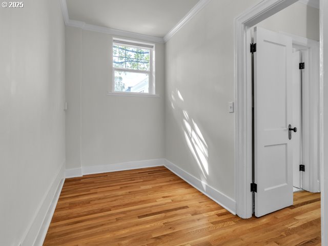 20 NW 16th Ave Unit 8, Portland, OR 97209 - spare room featuring crown molding, baseboards, and light wood-style floors