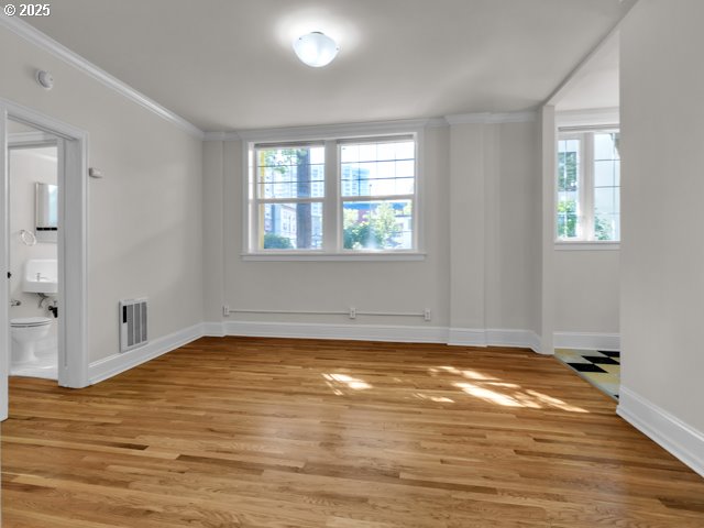 20 NW 16th Ave Unit 8, Portland, OR 97209 - empty room featuring visible vents, baseboards, a wealth of natural light, and light wood-type flooring