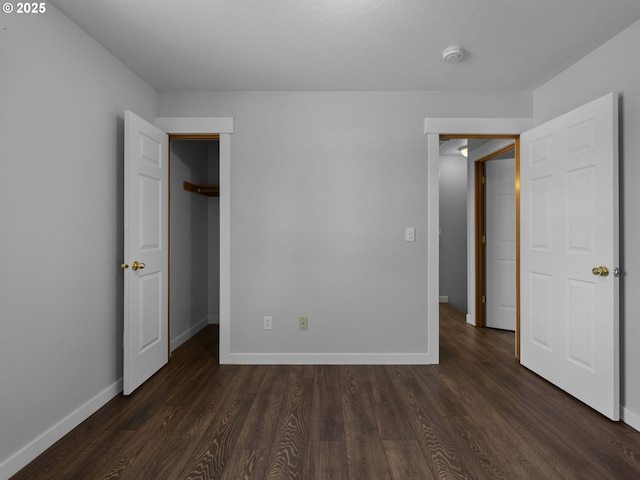 10727 NE Beech St, Portland, OR 97220 - unfurnished bedroom featuring dark wood finished floors, a walk in closet, and a closet