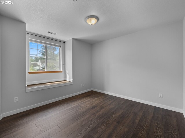 10727 NE Beech St, Portland, OR 97220 - spare room featuring dark wood-type flooring and a textured ceiling