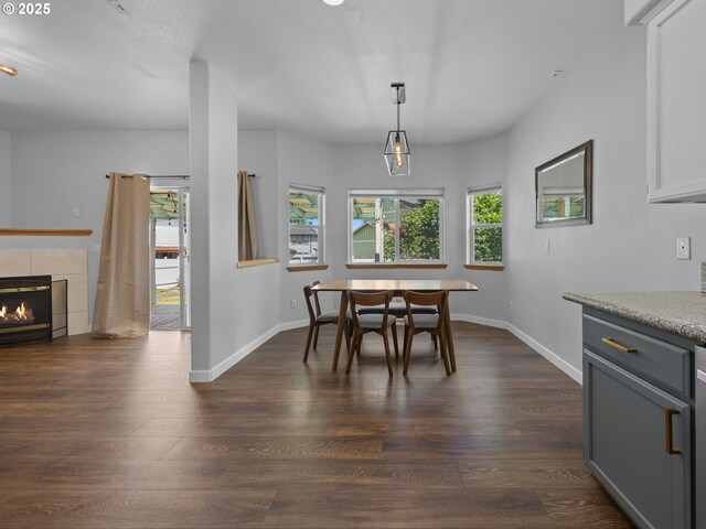 10727 NE Beech St, Portland, OR 97220 - dining space with dark wood finished floors and a tile fireplace