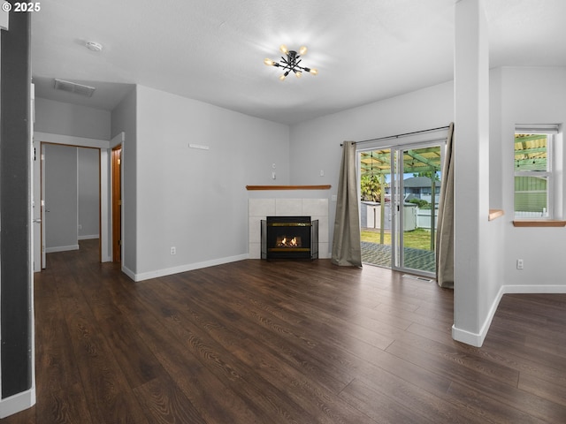 10727 NE Beech St, Portland, OR 97220 - unfurnished living room with dark wood-style flooring and a tiled fireplace