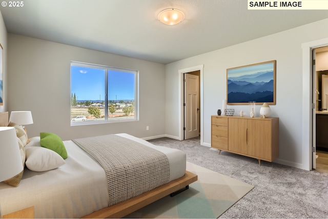 bedroom with light colored carpet and baseboards