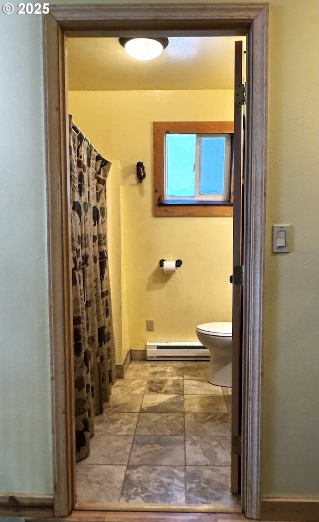 87 Adams Loop Rd, Goldendale, WA 98620 - full bathroom with toilet, baseboards, curtained shower, and a baseboard radiator