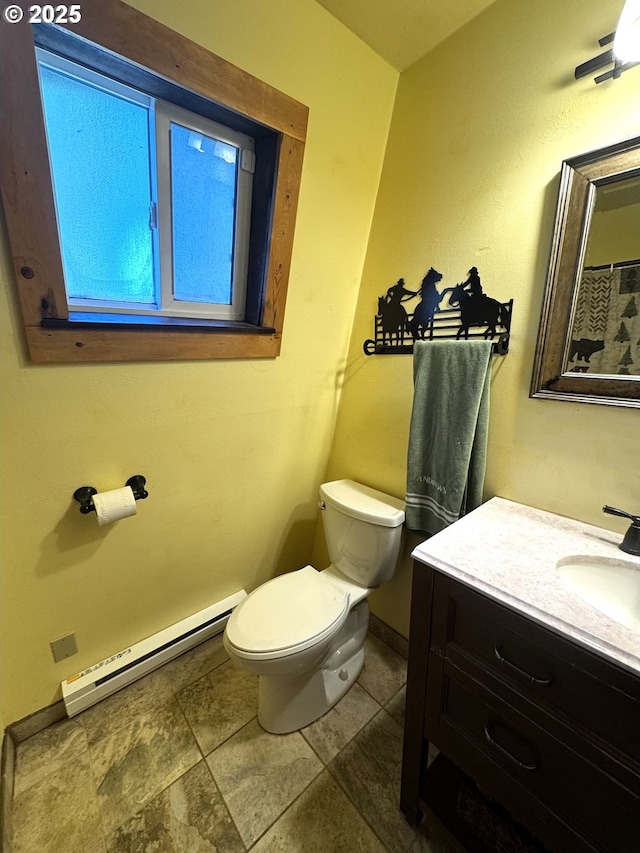 87 Adams Loop Rd, Goldendale, WA 98620 - bathroom featuring toilet, baseboards, baseboard heating, and vanity