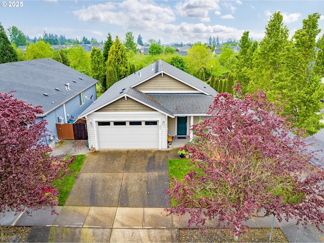 209 N 38th Pl, Ridgefield, WA 98642 - view of front facade with an attached garage, driveway, fence, and a shingled roof
