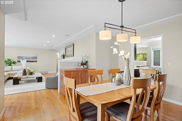 dining room featuring light wood-type flooring, recessed lighting, baseboards, and visible vents