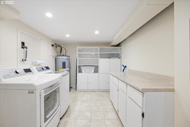 clothes washing area featuring independent washer and dryer, cabinet space, recessed lighting, light tile patterned flooring, and electric water heater