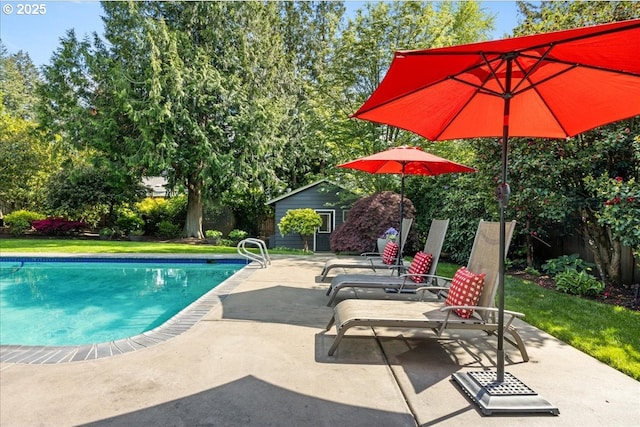 view of pool featuring a fenced in pool, a patio, and an outdoor structure