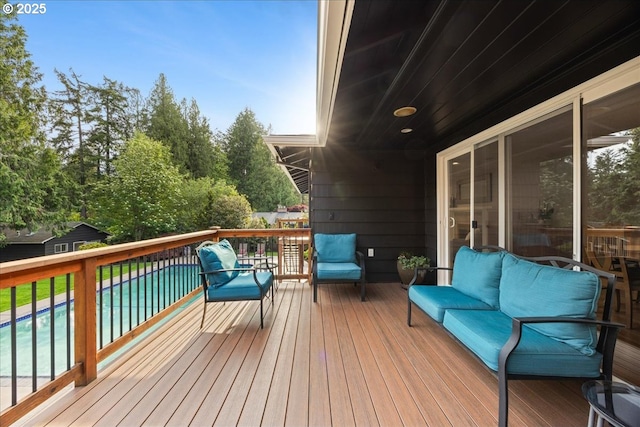 deck featuring a fenced in pool and outdoor lounge area