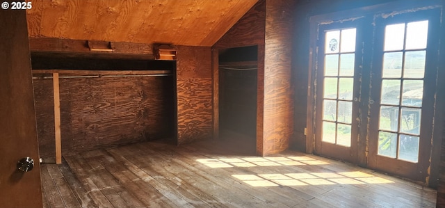 unfurnished bedroom with hardwood / wood-style floors, vaulted ceiling, multiple windows, and wood ceiling