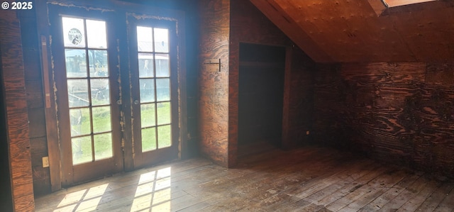 bonus room featuring hardwood / wood-style flooring, lofted ceiling, and plenty of natural light