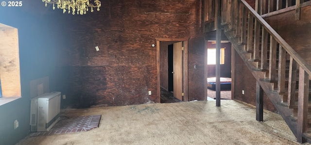 unfurnished living room featuring stairs