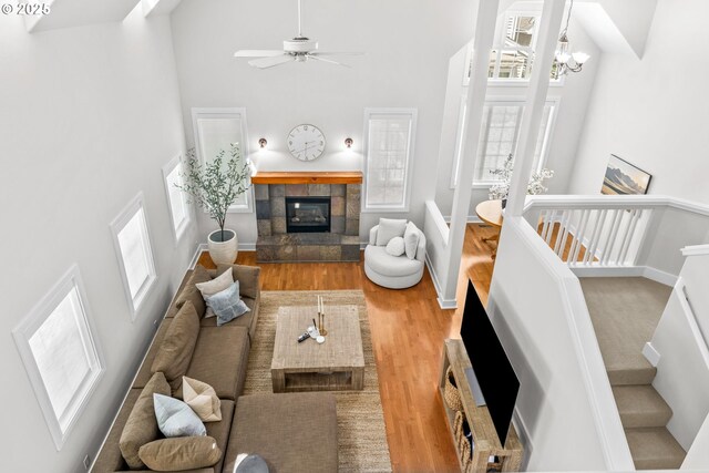 465 Covey Ln, Eugene, OR 97401 - living room with a high ceiling, wood finished floors, a fireplace, ceiling fan, and a chandelier