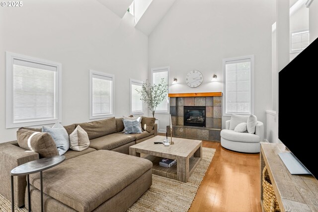 465 Covey Ln, Eugene, OR 97401 - living room featuring high vaulted ceiling, wood finished floors, and a tiled fireplace