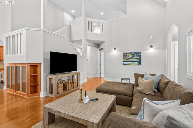 465 Covey Ln, Eugene, OR 97401 - living area featuring a high ceiling, wood finished floors, baseboards, arched walkways, and recessed lighting