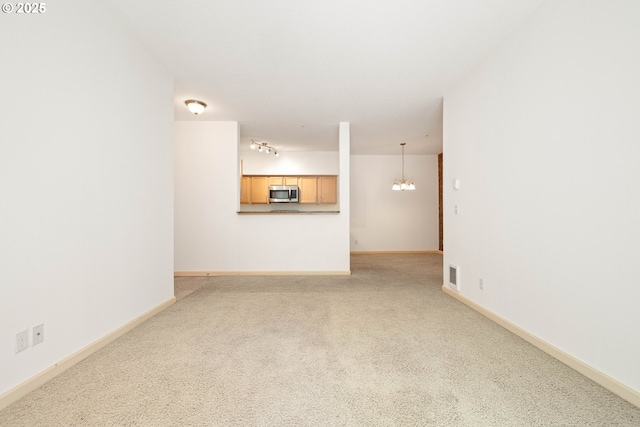 11830 NW Holly Springs Ln Unit 406, Portland, OR 97229 - unfurnished living room with carpet and a chandelier