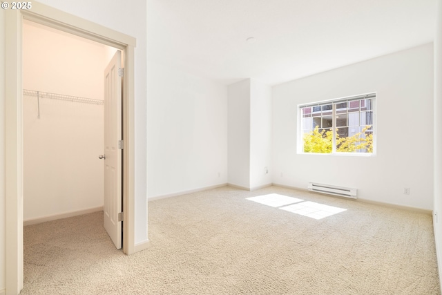 11830 NW Holly Springs Ln Unit 406, Portland, OR 97229 - unfurnished bedroom featuring a baseboard radiator, carpet floors, a spacious closet, and a closet