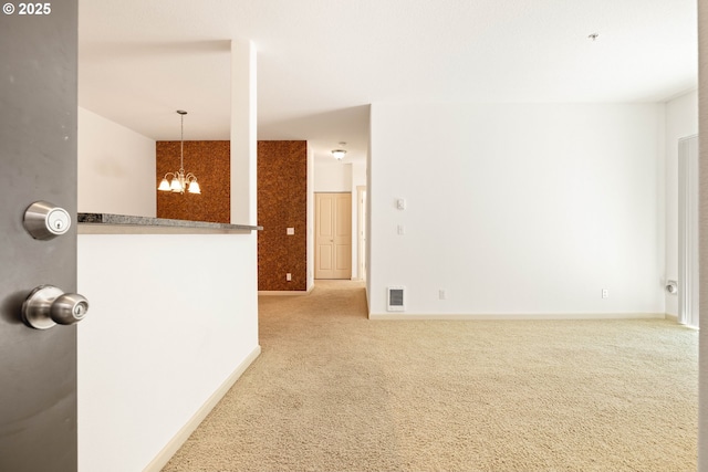 11830 NW Holly Springs Ln Unit 406, Portland, OR 97229 - carpeted spare room featuring a chandelier and baseboards