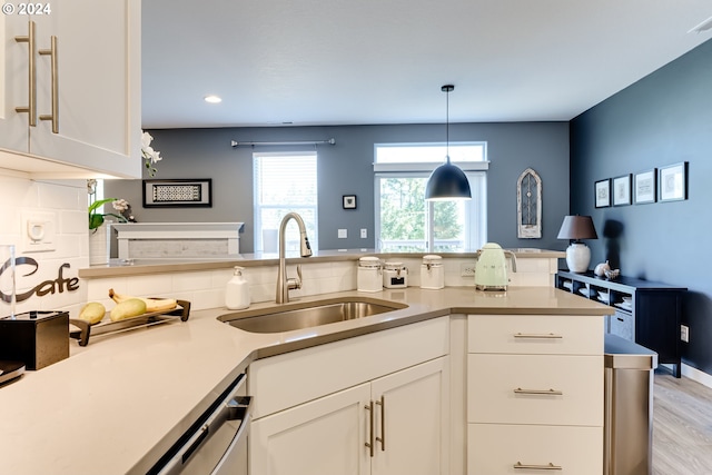 kitchen featuring a sink, white cabinets, light countertops, decorative light fixtures, and recessed lighting