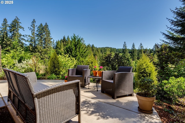 view of patio with a forest view
