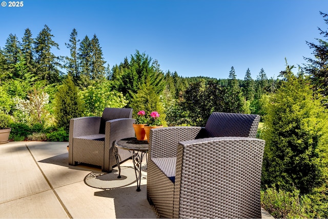 view of patio / terrace with a wooded view