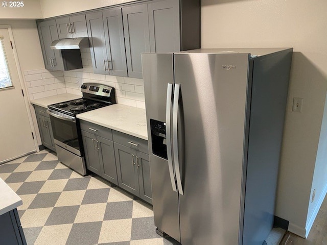 kitchen featuring appliances with stainless steel finishes, tasteful backsplash, and gray cabinetry