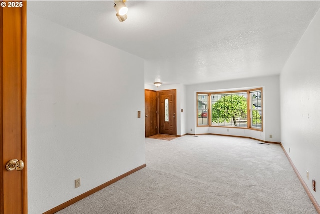 carpeted spare room with baseboards