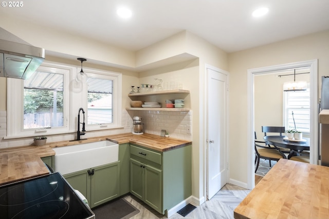 2535 N Baldwin St, Portland, OR 97217 - kitchen featuring wooden counters, green cabinets, recessed lighting, tasteful backsplash, and range with electric cooktop