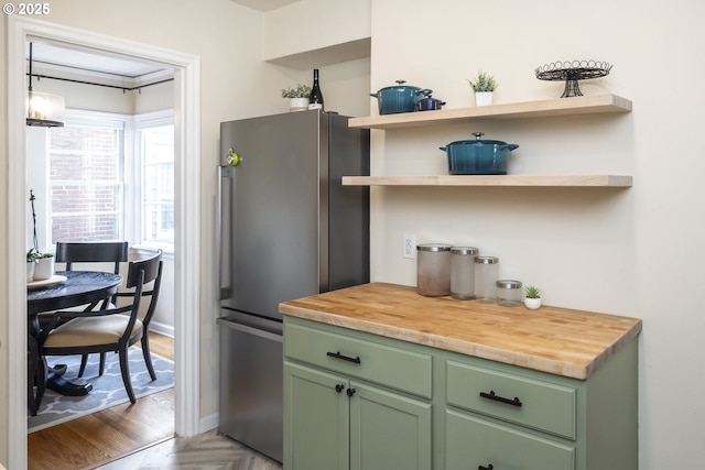 2535 N Baldwin St, Portland, OR 97217 - kitchen with green cabinets, freestanding refrigerator, and wood counters
