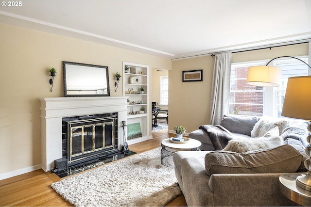 2535 N Baldwin St, Portland, OR 97217 - living room featuring a fireplace with flush hearth, wood finished floors, and healthy amount of natural light