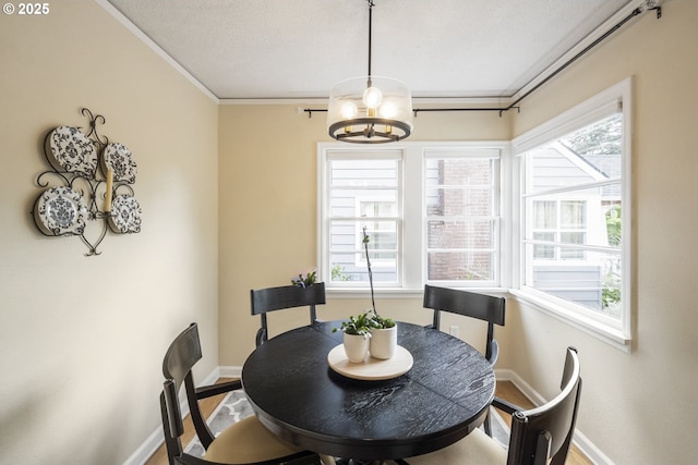 2535 N Baldwin St, Portland, OR 97217 - dining room featuring wood finished floors, ornamental molding, and a chandelier